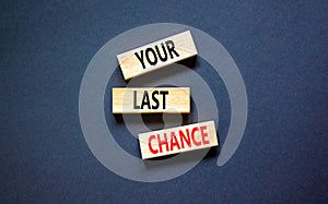 Time to your last chance symbol. Concept words Your last chance on wooden blocks on a beautiful black table black background.