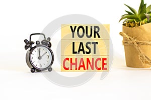 Time to your last chance symbol. Concept words Your last chance on wooden blocks on a beautiful white table white background.