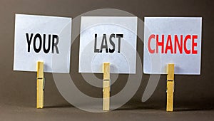 Time to your last chance symbol. Concept words Your last chance on white paper on a beautiful grey table grey background. Business