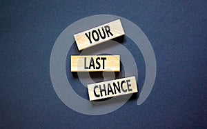 Time to your last chance symbol. Concept words Your last chance on wooden blocks on a beautiful black table black background.