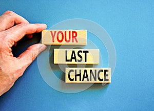 Time to your last chance symbol. Concept words Your last chance on wooden blocks on a beautiful blue table blue background.