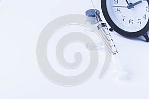 Time for vaccination. Watch and syringe with vaccine. Date and time of preventive vaccinations to population.
