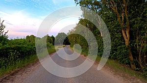 Time warp of a walk on a road next to a forest lake