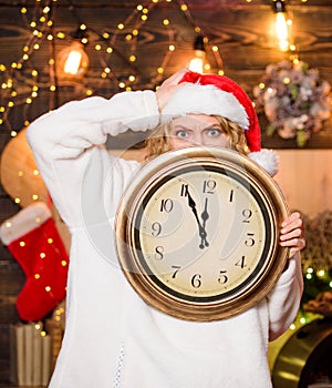 Time for winter party. Woman Santa hat hold vintage clock. Time to celebrate. Merry christmas. Time for miracles. Few