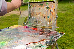 Time-worn painter's sketchbook with multicolored palette outdoor