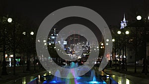 Timelaps at night City, fountain in front and city, factory, warship background. Novorossiysk.