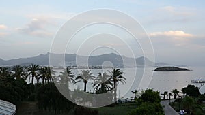 Timelaps of sunset and beach with a view on Bodrum resort in night illumination