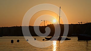 The timelaps of sunset and view on Sliema and sail yacht with Ukrainian flag