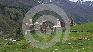 Timelaps video grazing horses against the backdrop of mountains and village, Ushguli, Georgia