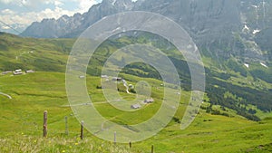 Timelapse aerial view on a meadow in the Swiss Alps. Cable Car operating during summer. Grindelwald, Bernese Oberland, Canton Bern