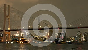 Timelapse,busy shipping on river,across the sea bridge,Brightly urban building.