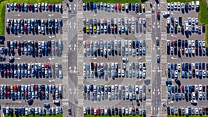 Timelapse car driving and standing on green parking top view from flying drone