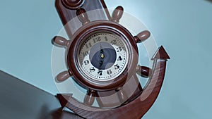 Timelapse of the clock in the shape of an anchor and a ship`s helm