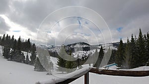 Timelapse clouds floating the sky. Snowed hills and mountains. Winter time.