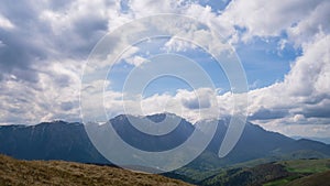 Timelapse of clouds over the main ridge of Bucegi mountains, Romania, part of Carpathians, as seen from Baiului mountains.