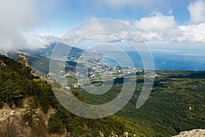 Timelapse cloudscape of Yalta city in the Ai-Petri crimean mountains. Flowing clouds above the blue sea and town. Crimea