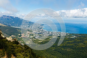 Timelapse cloudscape of Yalta city in the Ai-Petri crimean mountains. Flowing clouds above the blue sea and town. Crimea