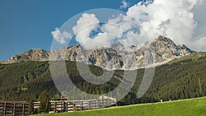 Timelapse of dancing clouds above the mountains. Mountain landscape. Piz Mitgel mountain, Albula Range of the Alps, Savognin,