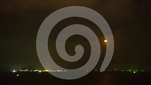 Timelapse of dramatic panorama of bright moon at sea in Thailand. Mysterious moon moving across sky