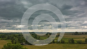 Timelapse of dramatic sky above rural landscape Stormy clouds moving countryside