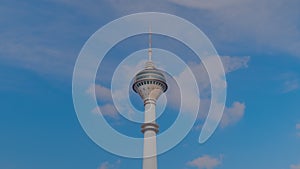 Timelapse: Endem TV Tower against the blue sky with fast moving white clouds