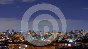 Timelapse: fast moving clouds over living apartment building in Turkey at night