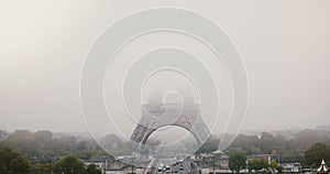 Timelapse of foggy Eiffel Tower. Paris, France. Atmospheric mystic background opening 4K. Street traffic. Bad weather.