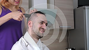 Timelapse getting haircut at home during quarantine. Wife uses a hair clipper to shorten husband hair.