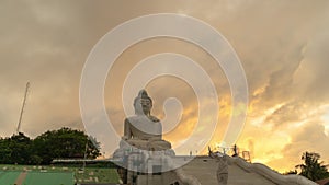 .timelapse golden cloudy at sunset behind Phuket big Buddha