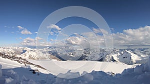 Timelapse from a height of 4000 meters high snow-capped rocks with glaciers and mountains of the main Caucasian ridge