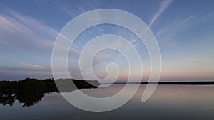 Timelapse of high altitude clouds over West Lake in Everglades at sunset 4K.