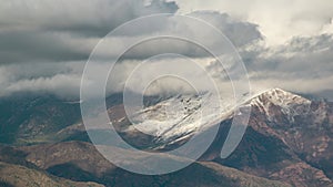 Timelapse of high mountains view with flowing clouds