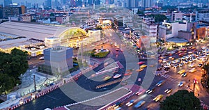 Timelapse high view of traffic at junction with view of Bangkok city at twilight