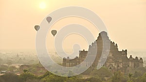 Timelapse of Hot air balloon over plain of Bagan in misty morning before sunrise, Myanmar