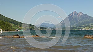 Timelapse Kitesurfing. Surfers jumping in the waves and surf on a lake in the Swiss Alps. Sarnersee, Lake Sarnen, Canton Obwalden