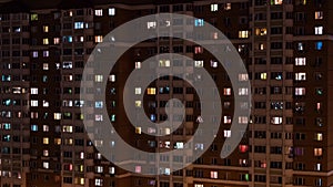 Timelapse of living apartment building windows at night - facade view