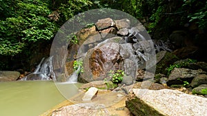 Timelapse long exposure tracking shot of Small Waterfall in beautiful rainforest at Phuket Thailand
