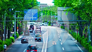 A timelapse of miniature traffic jam at the avenue daytime in the downtown tiltshift zoom