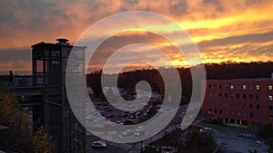 Timelapse of modern glass elevator in front of technical center Cesana on the background of sunset, Mlada Boleslav, Czech Republic