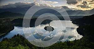 Timelapse of mountain landscape at sunrise with sunlight hitting Lake Bled island in Slovenia. Time