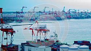 A timelapse of moving cranes at the bay area in Tokyo tiltshift panning