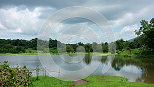 Timelapse of nature landscape Clouds over lake or pond movement of water and clouds waves water surface during the day against a b