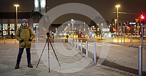 Timelapse of night street with man shooting video. Helsinki, Finland