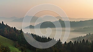 Timelapse panoramic foggy landscape at dawn over mountain and valley. Slovenia. Dancing fog