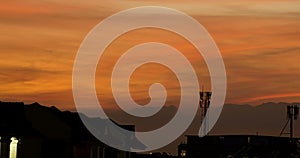 Timelapse and passing cloud with sunset on orange sky