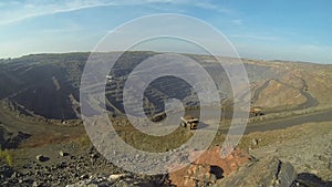 Timelapse quarry. Iron ore mining. Huge quarry on which BelAZ and excavators drive.