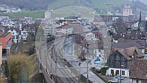 Timelapse of Railway Tracks in the town with passing by trains. Ingenbohl, Canton Schwyz, Switzerland