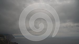 Timelapse rainy Nimbostratus clouds moving in bright sunset sky over stormy sea. Abstract aerial nature summer ocean