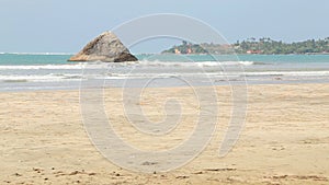 Timelapse of sandy beach and small island in Weligama, Sri Lanka.