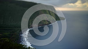 Timelapse selective focus of Waipio valley overlook with water movement on the beach